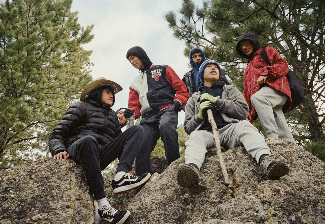 Children from the local indigenous communities sitting on a rock after a hike.