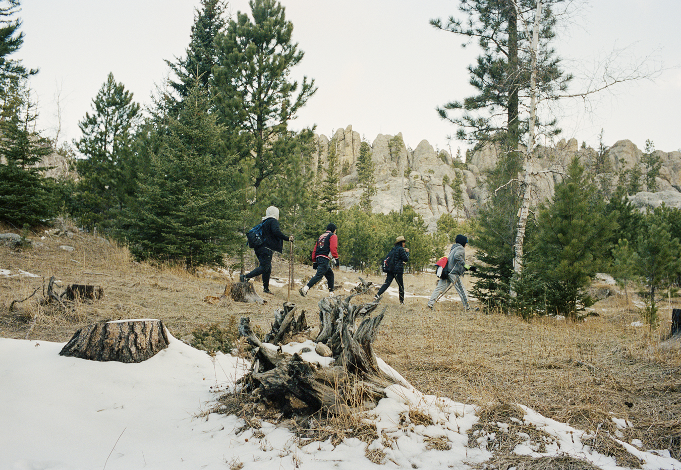 local indigenous people hiking through forests and snow covered grounds for the Standing Rock star knowledge ceremony