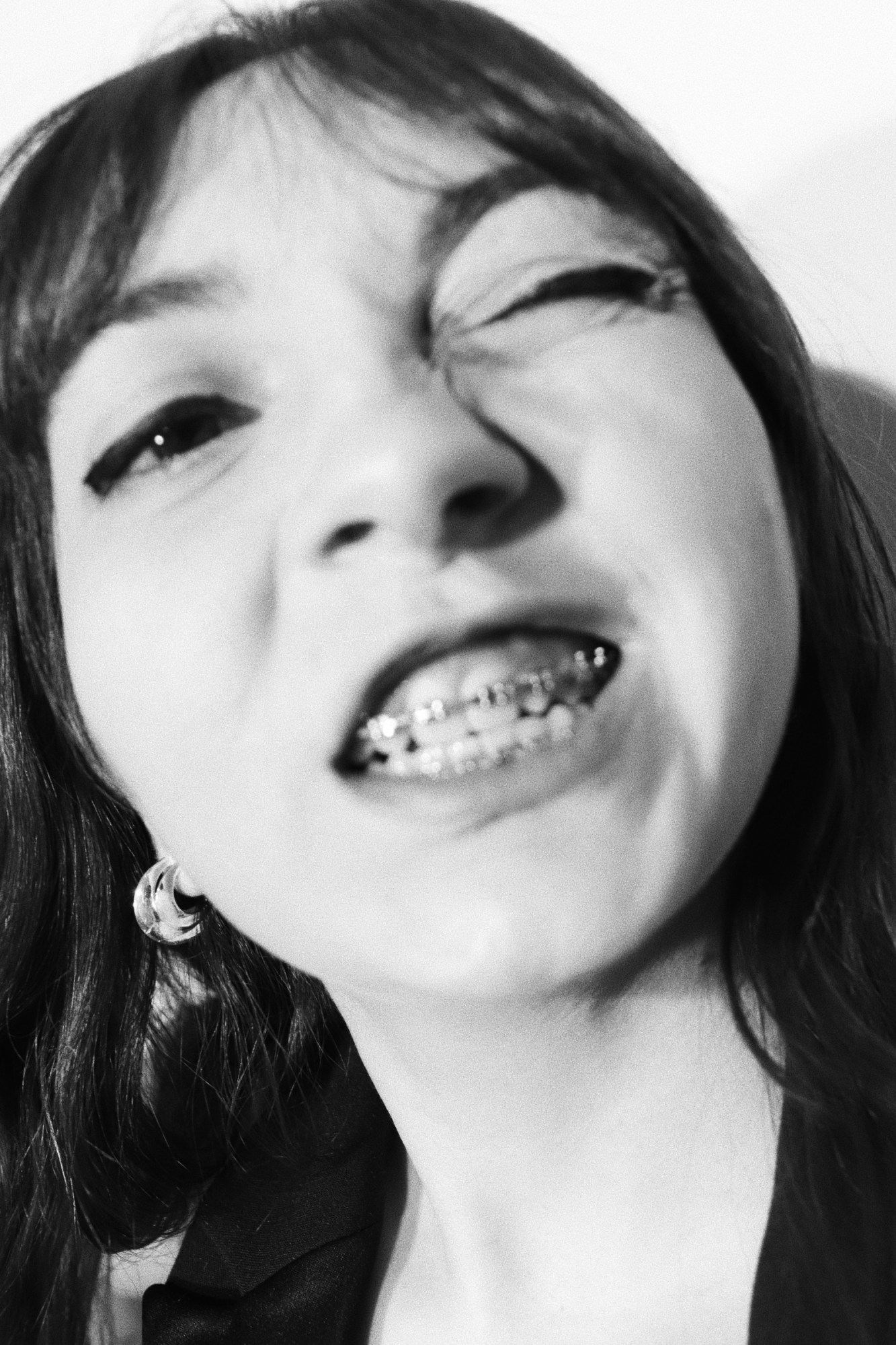 a close up of a girl with braces and winking