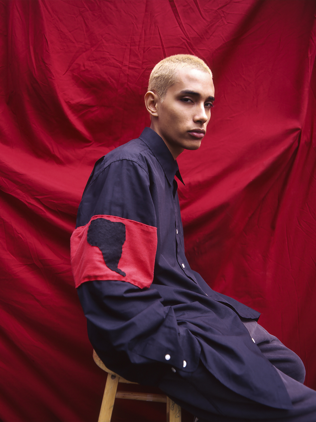 model wearing a shirt with South America printed on the sleeve.