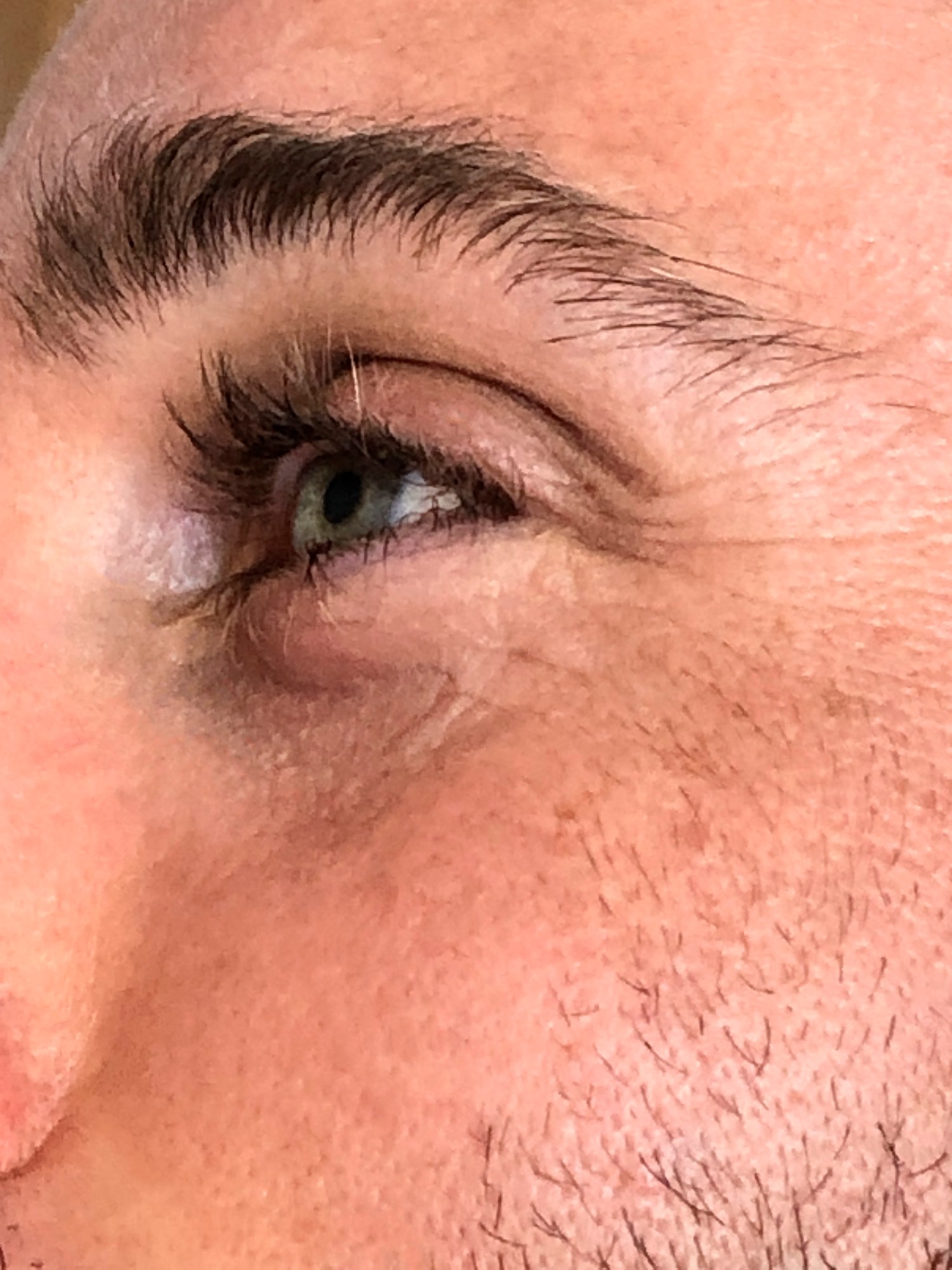 a close up of a man's cheek and eye