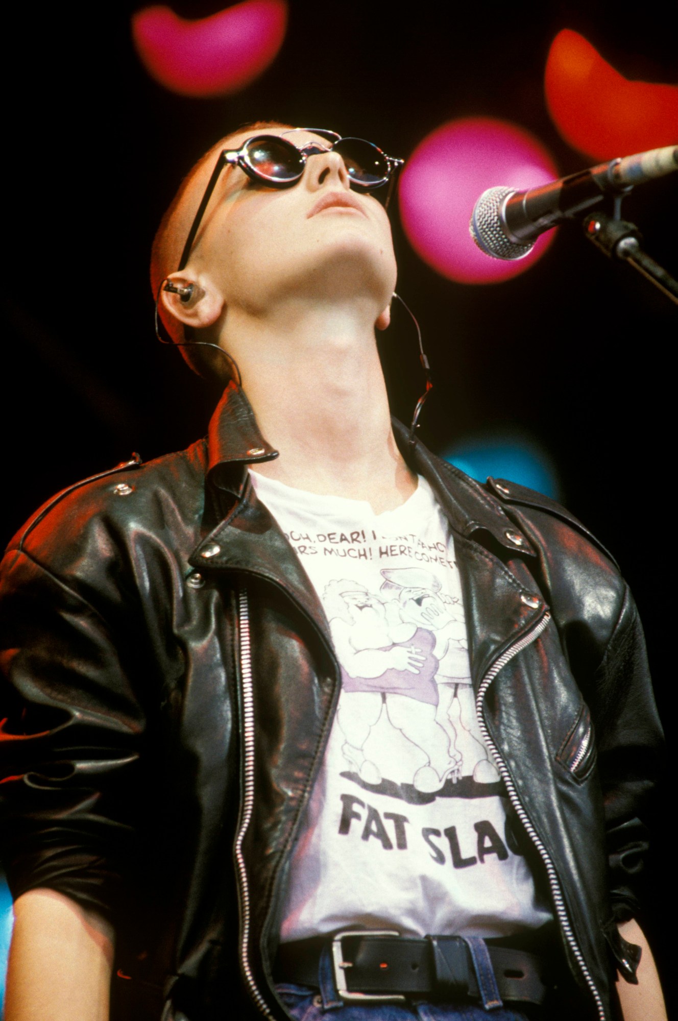 Sinead O'Connor wearing a tee that says Fat Slags with a leather jacket and jeans on the pyramid stage at Glastonbury