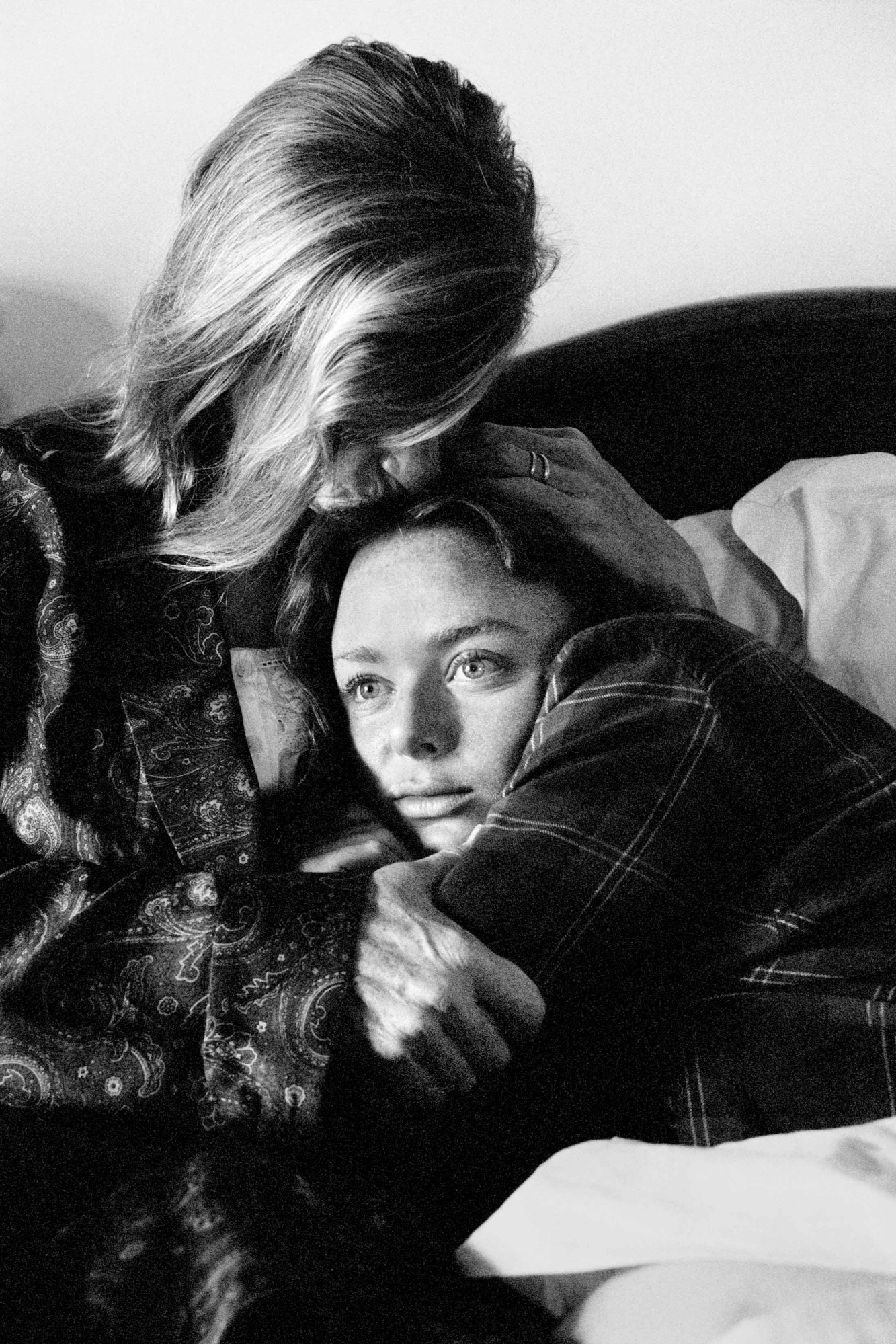 Linda and Stella McCartney embrace on a bed