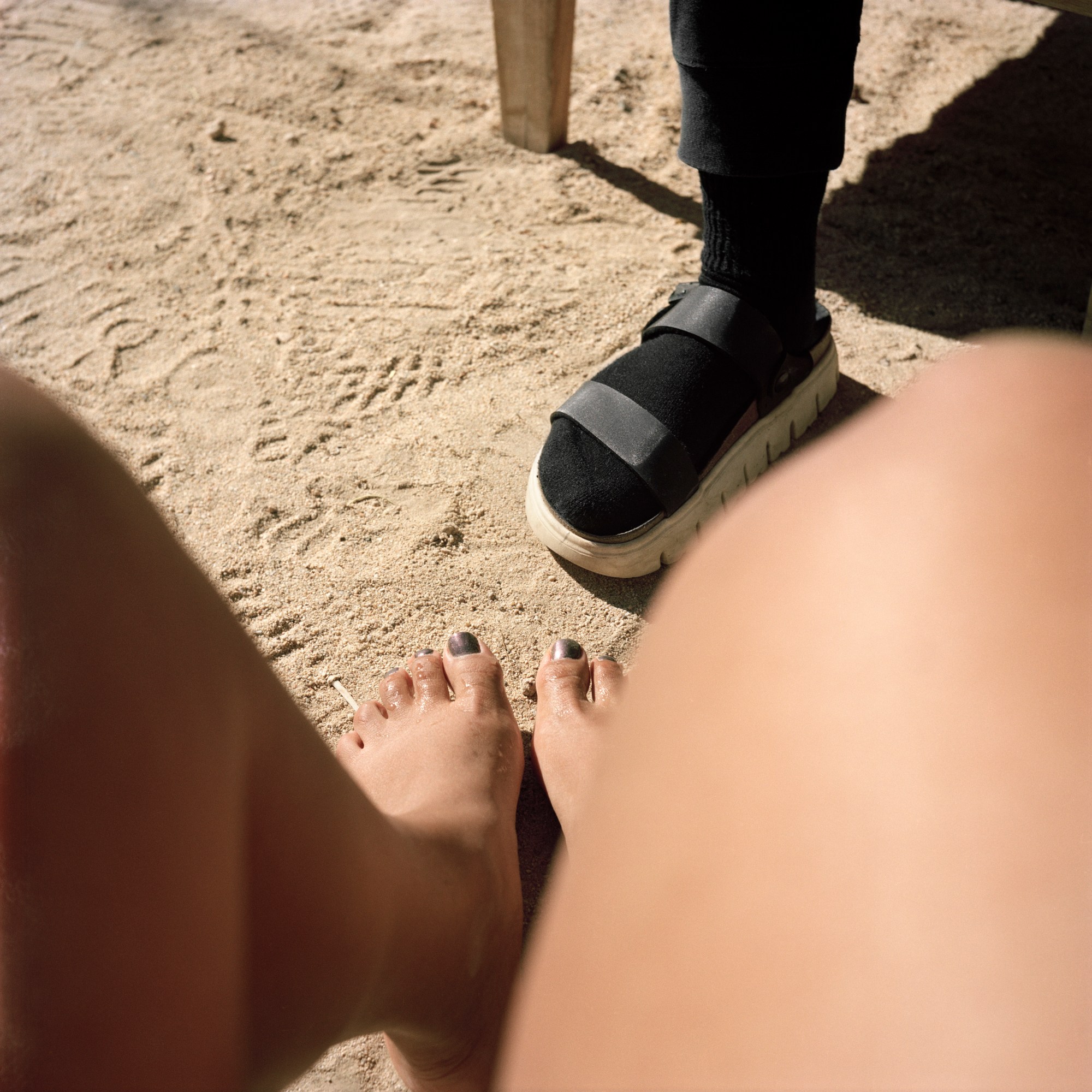 bare feet and sandal on the sand