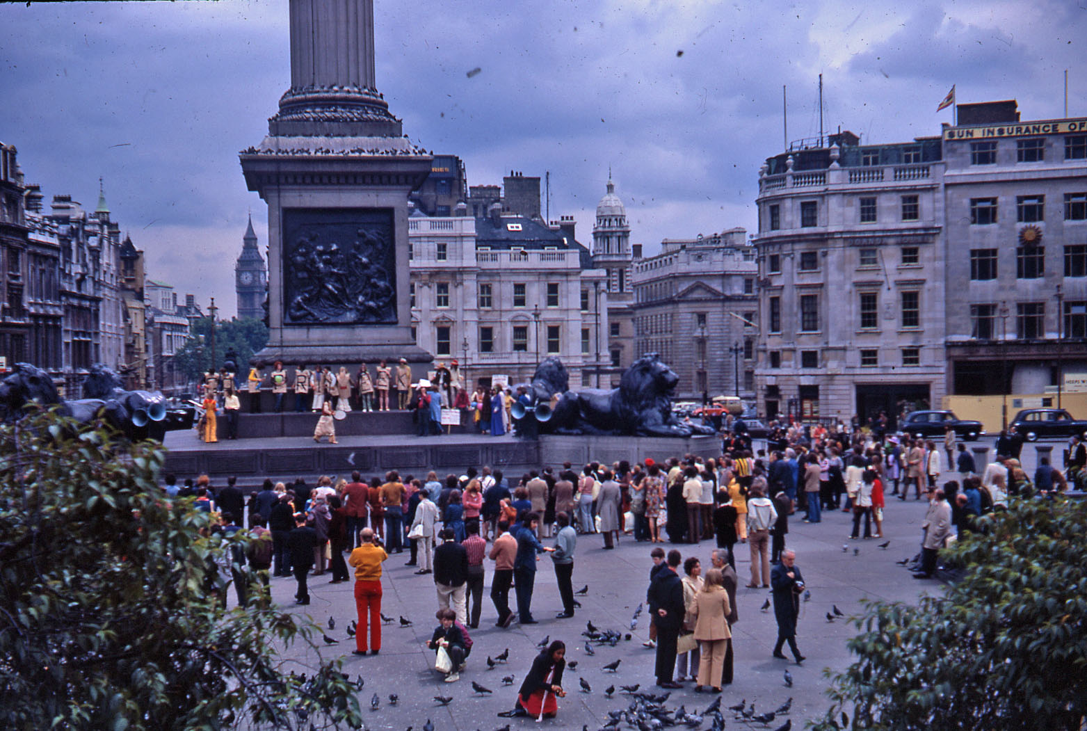 Protesters holding signs and banners on the plinth in Trafalgar Square at the 1972 pride march