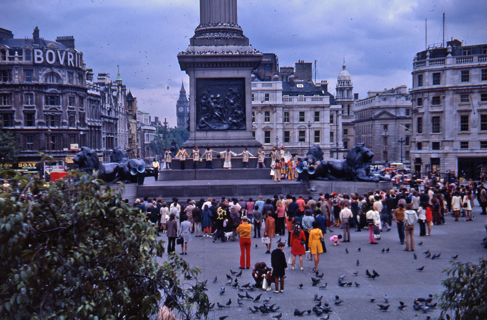 Protesters holding signs and banners on the plinth in Trafalgar Square at the 1972 pride march