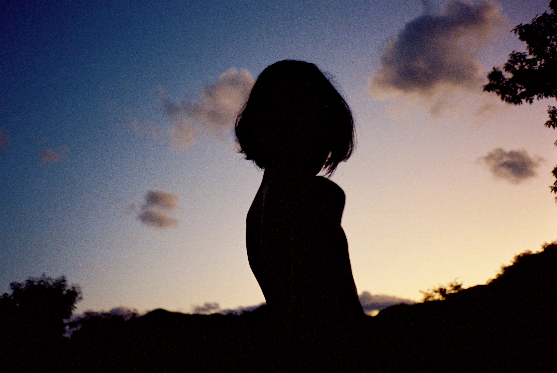 photo of a silhouette of a person outside at sunrise.