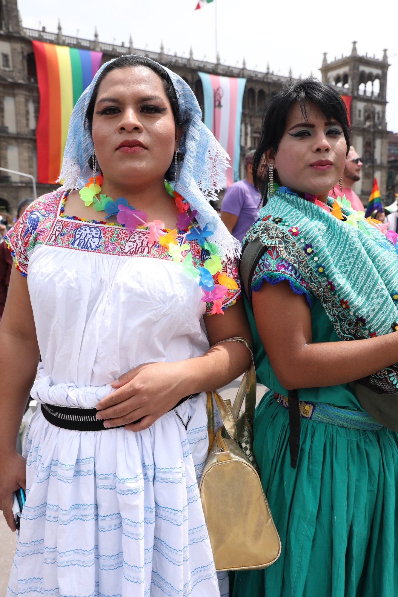 two people in dresses and a rainbow garland at Mexico Pride 2022