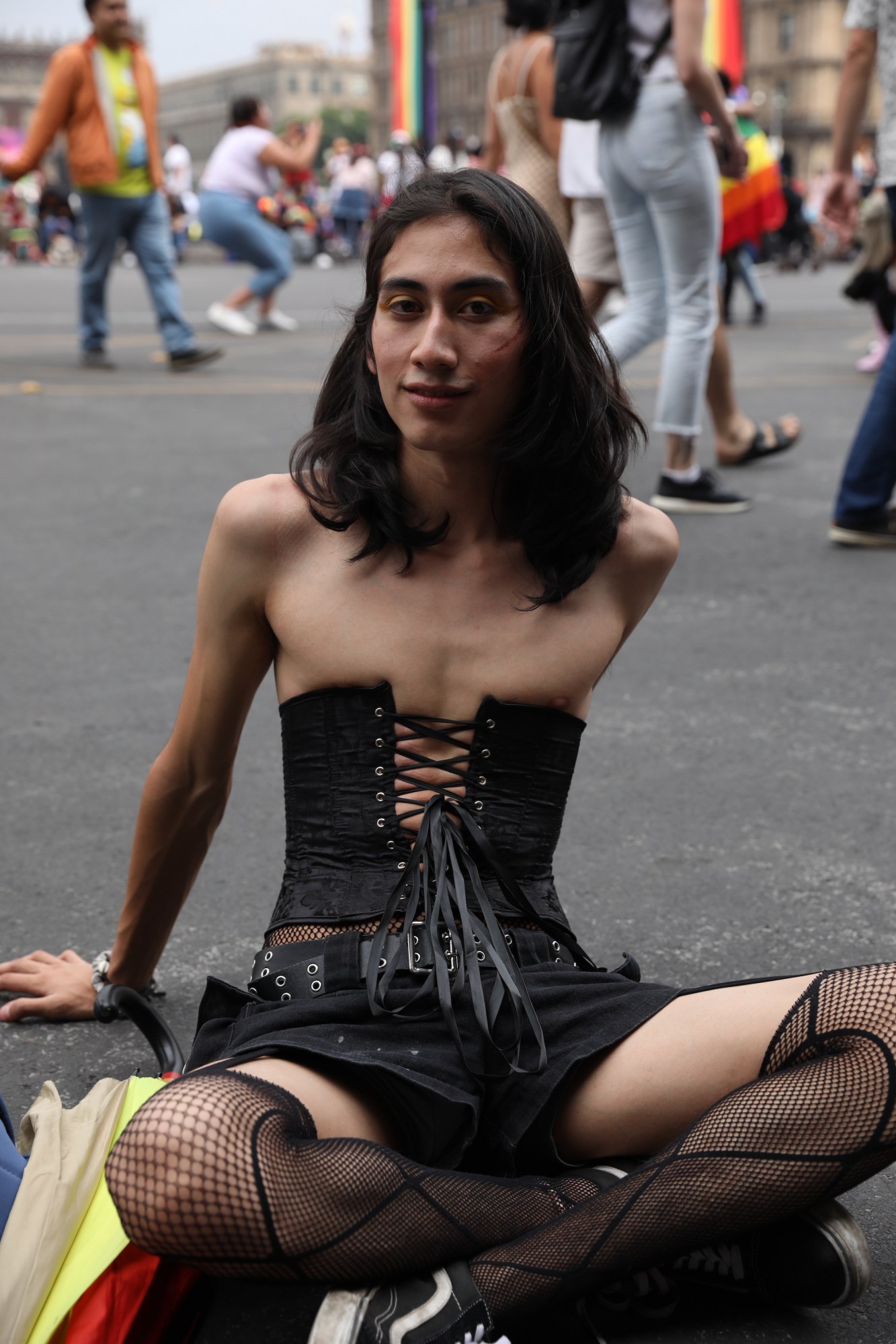 person in all black sitting on the floor at Mexico Pride 2022