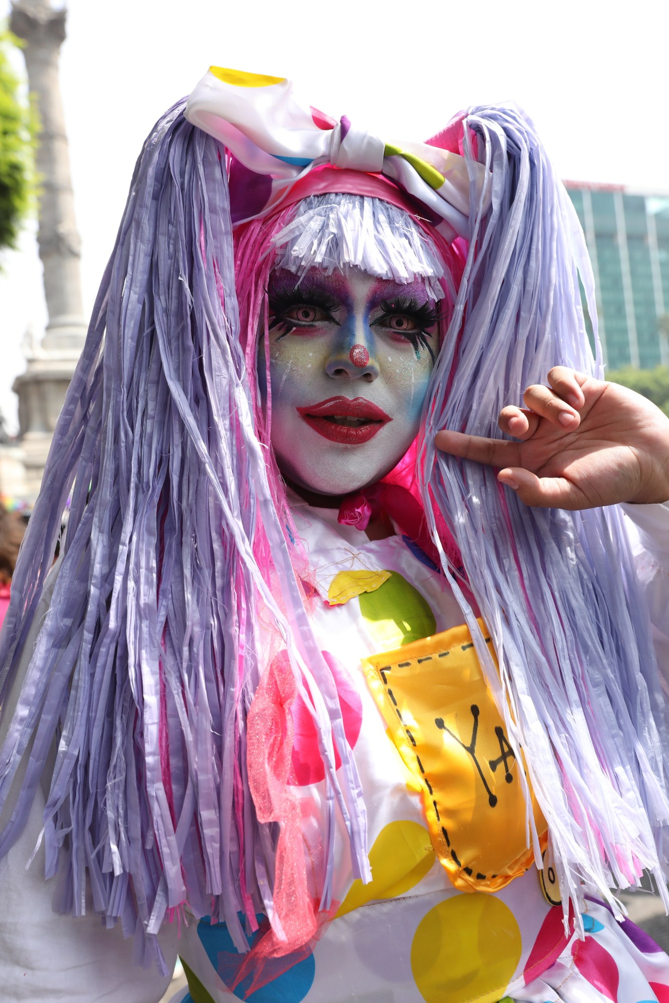 drag artist with a white colourful spotted dress and purple fringe hair at Mexico Pride 2022