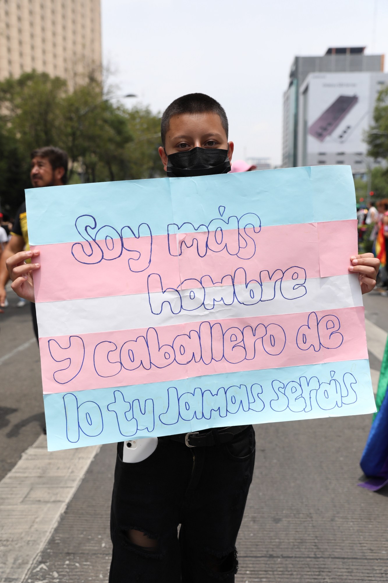 person holding a trans pride sign at Mexico Pride 2022