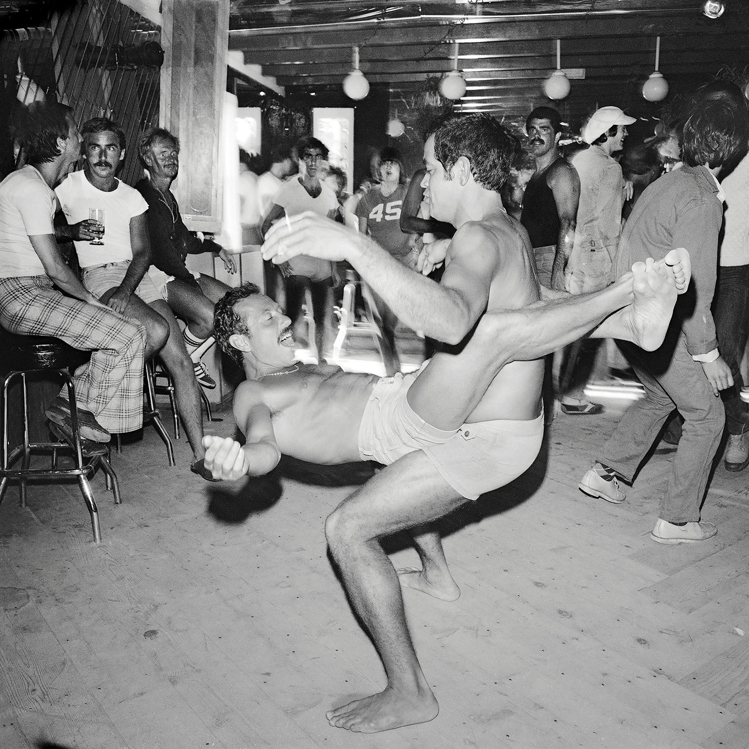 a couple dancing wrapped around each other on the dance floor