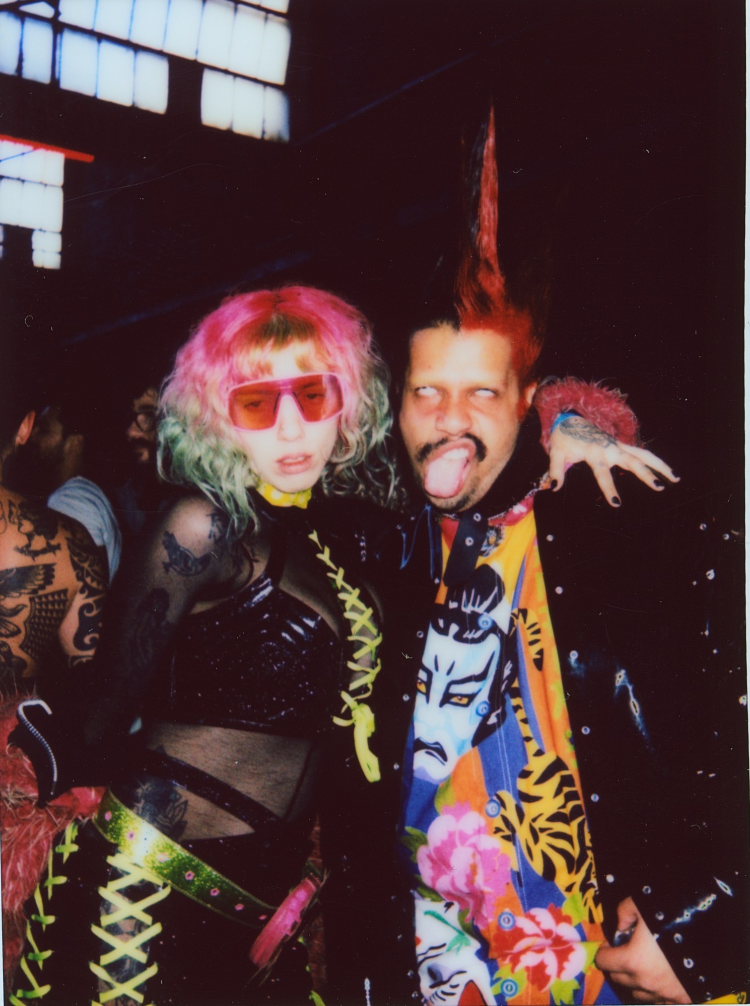 a couple with colorful hair and clothes at a rave in brazil