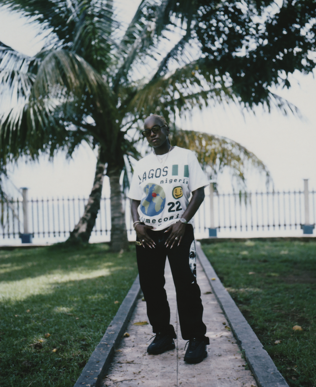 Person standing outside in white tee and black jeans in I-D 369 The Earthrise Issue