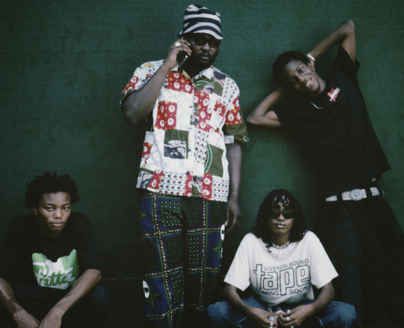 four people posing against a green wall in I-D 369 The Earthrise Issue