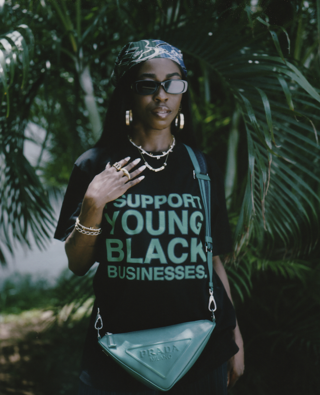 Person standing outside wearing a tee that says support young black businesses in I-D 369 The Earthrise Issue