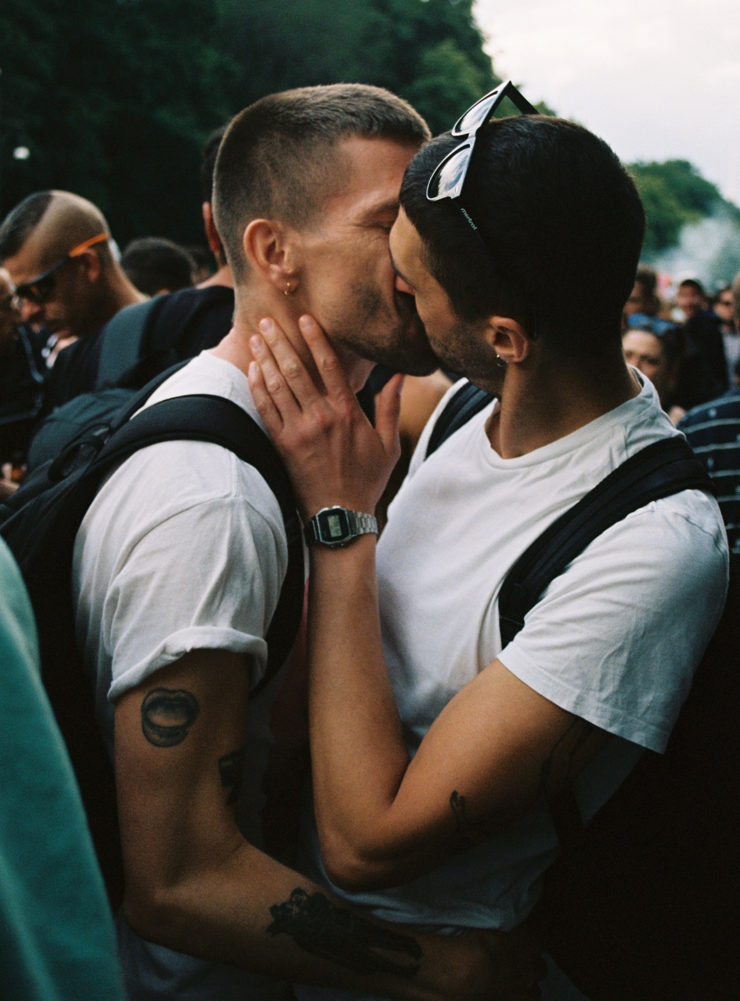 two men in white T-shirts kiss