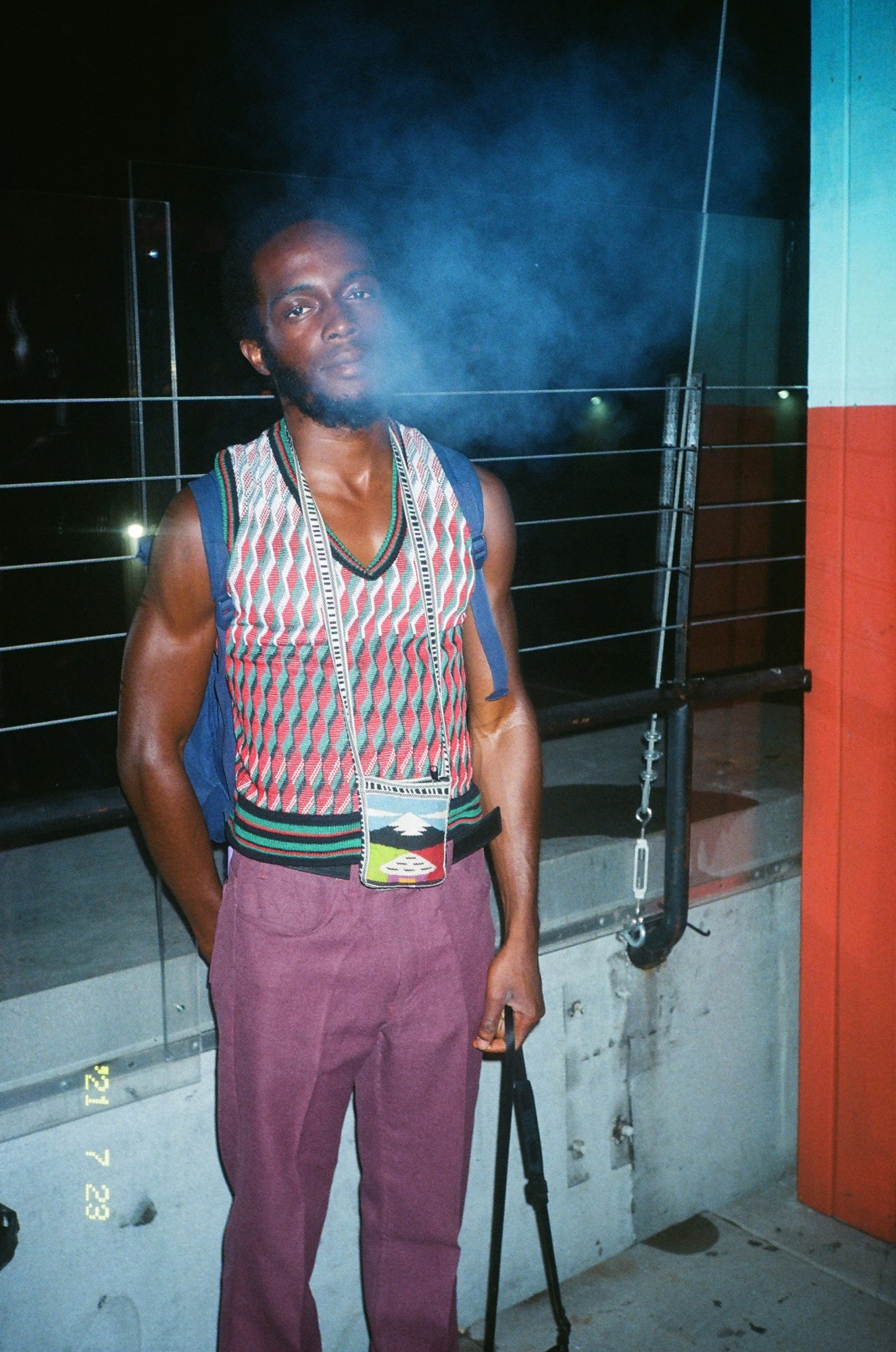 Man standing on a rooftop in Williamsburg Brooklyn at night