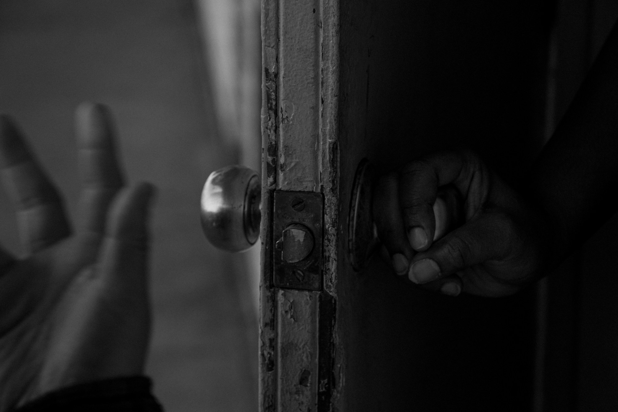 A resident opening the door at the Lincoln Tunnel Hotel.