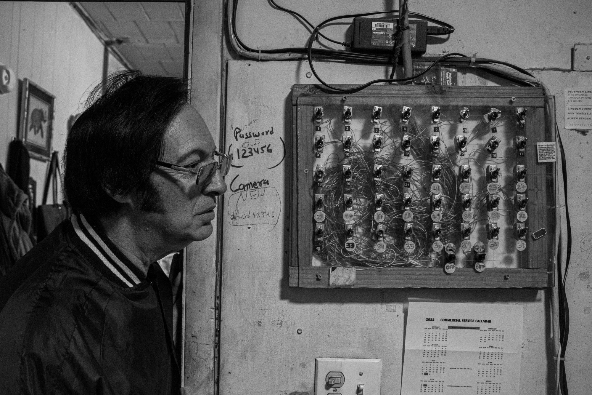 A man wearing vintage glasses inside he Lincoln Tunnel Hotel.