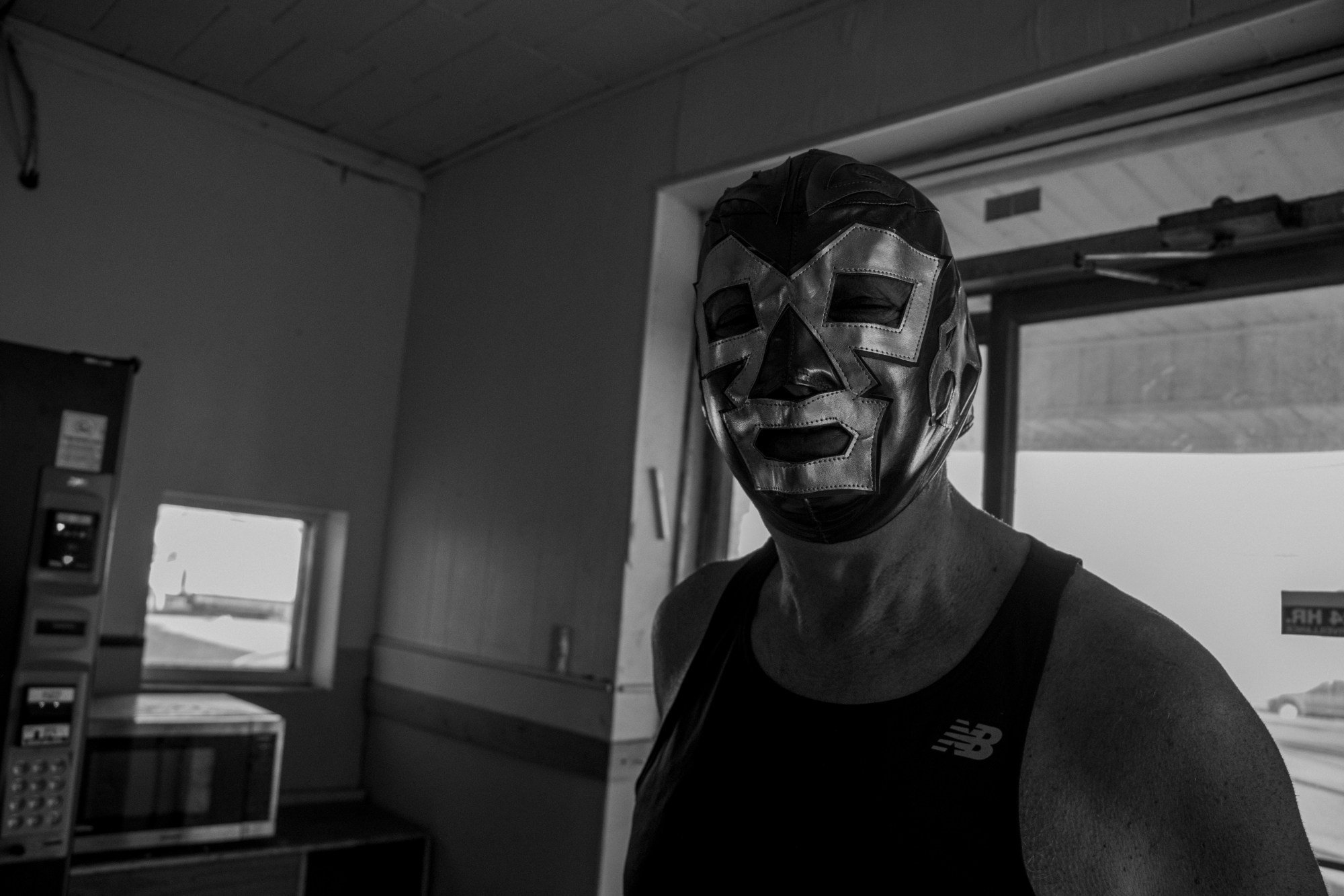 A man wearing a mask inside the Lincoln Tunnel Hotel.