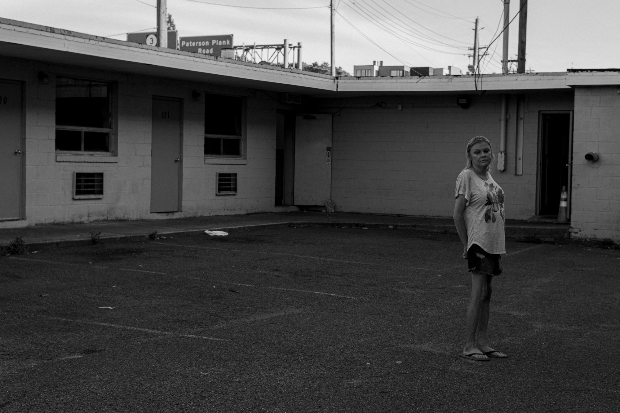 A woman standing outside the Lincoln Tunnel Hotel.