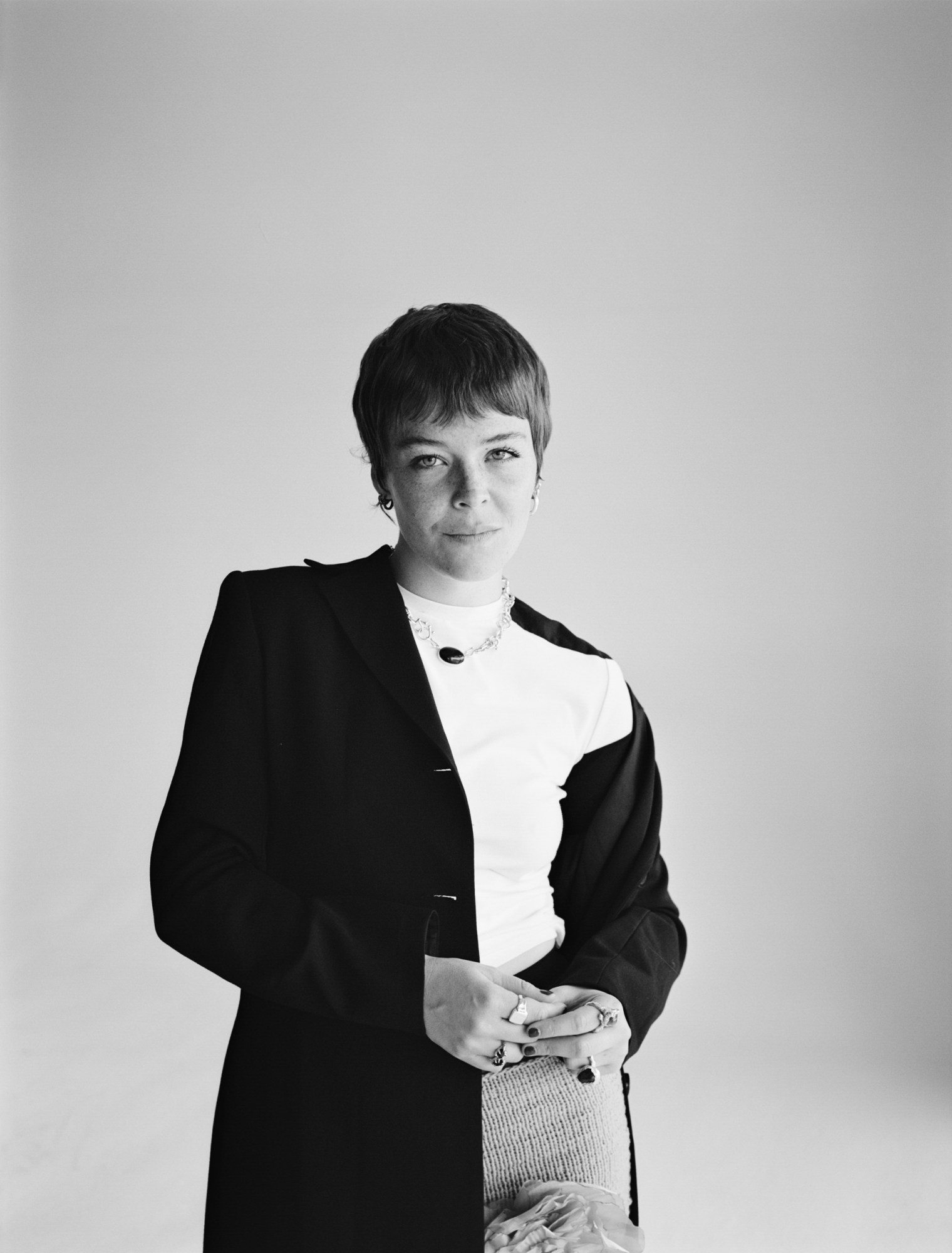 a black and white photo of maggie rogers in a black blazer and white tee