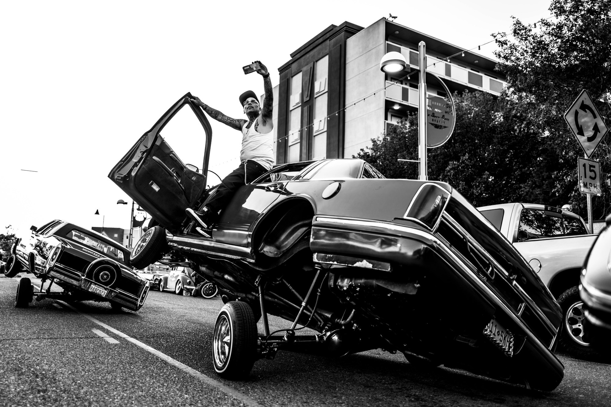 a man taking a selfie in a lowrider car