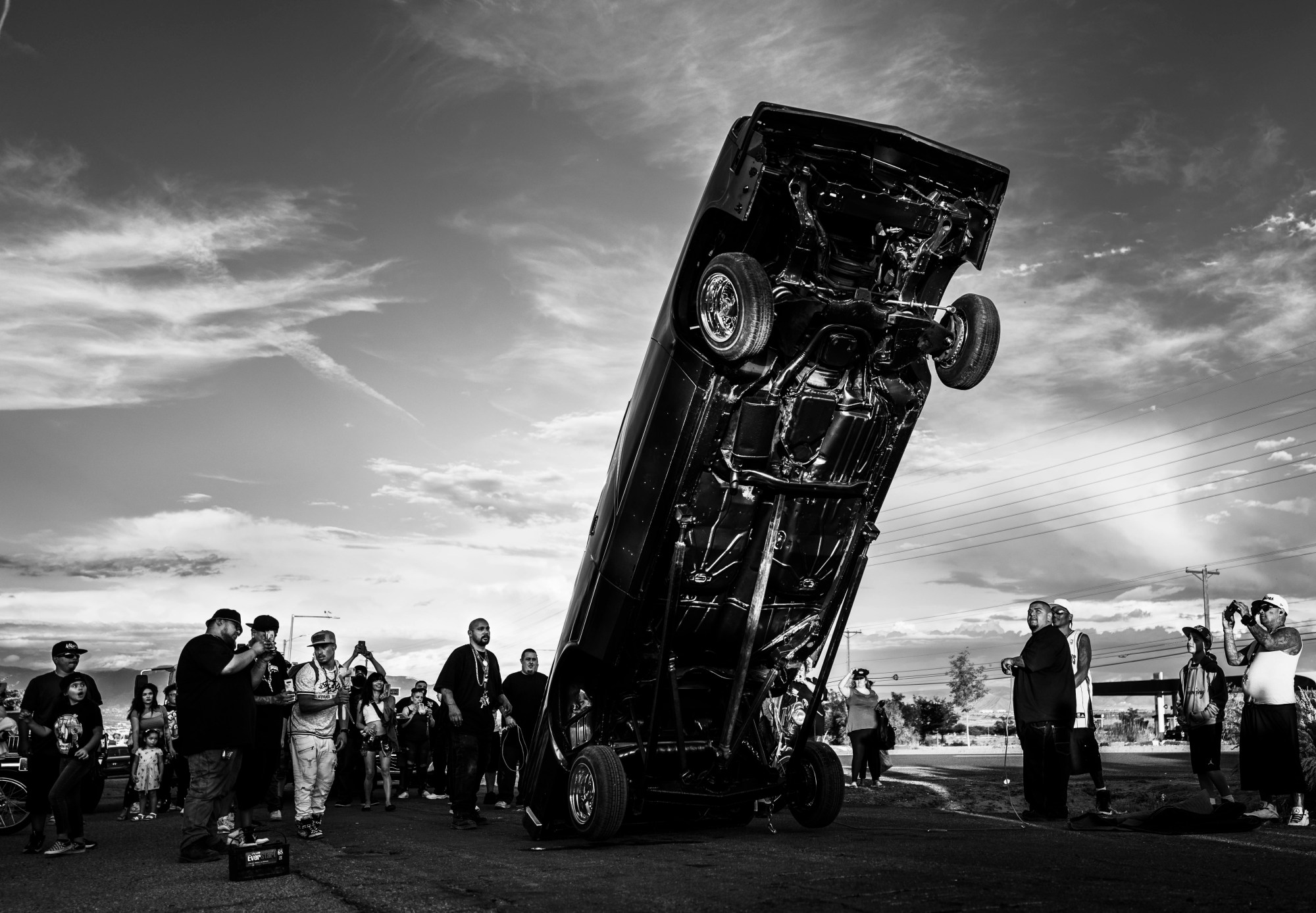 a lowrider car on it's rear wheels in downtown albuquerque