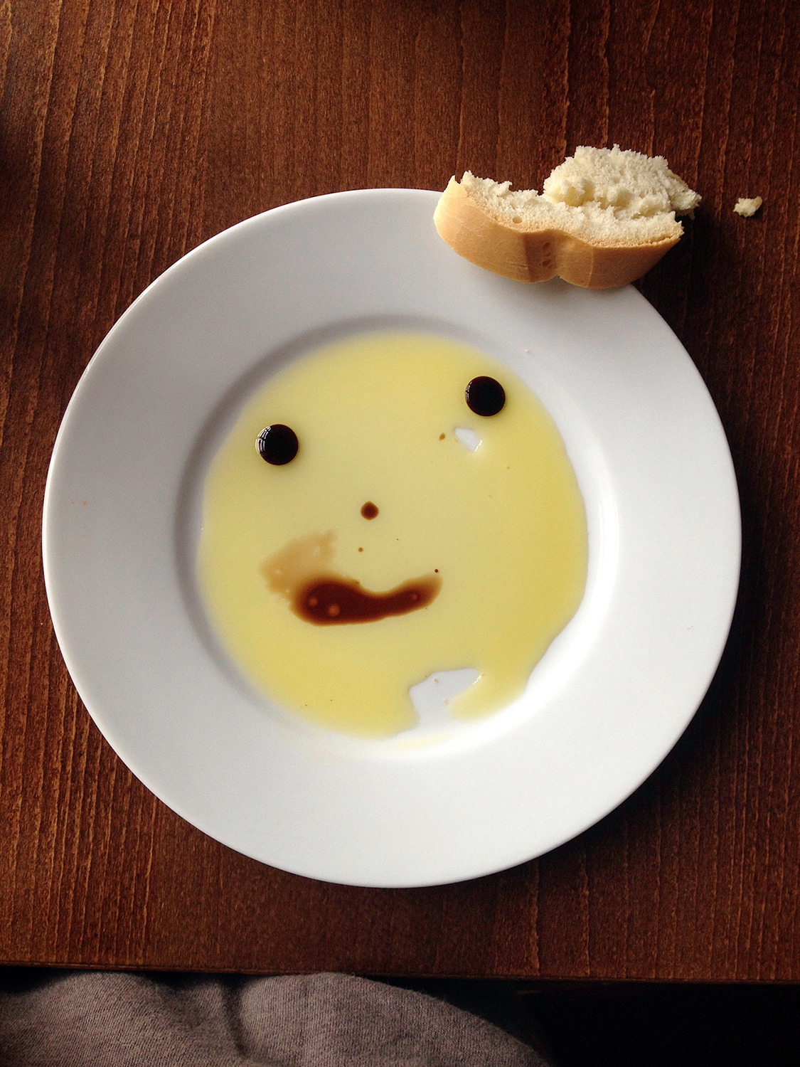 a plate with leftover food that resembles a smiley face