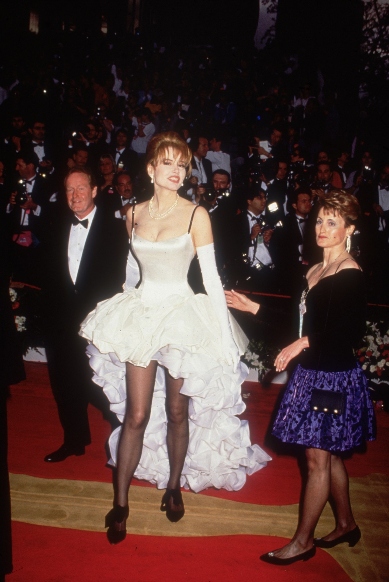 geena davis wearing a ruffle corset dress on the red carpet at the academy awards 1992