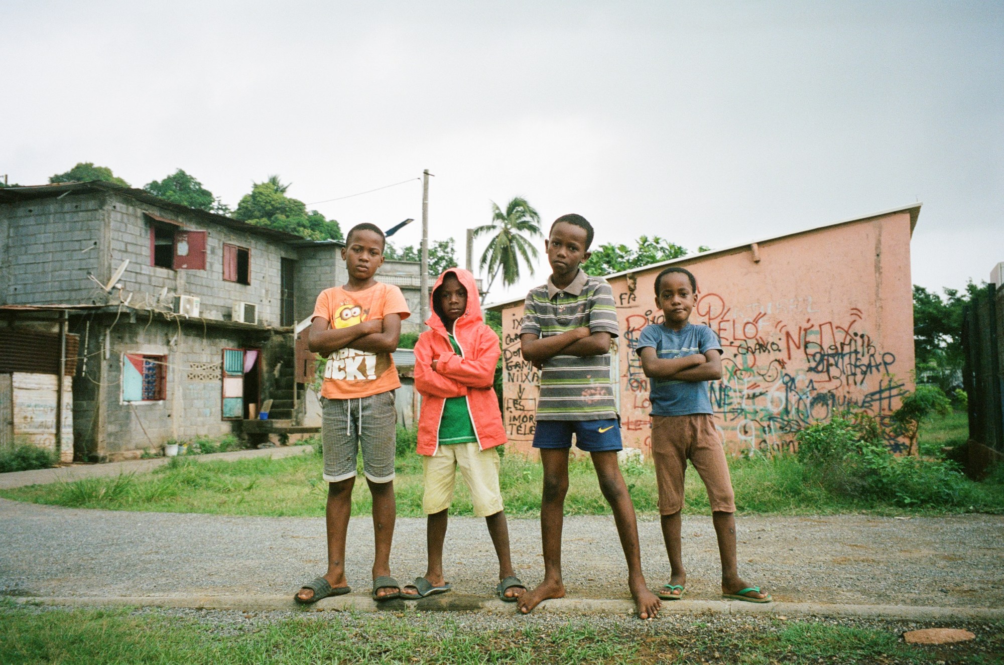 four young boys posing for a portrait with crossed arms