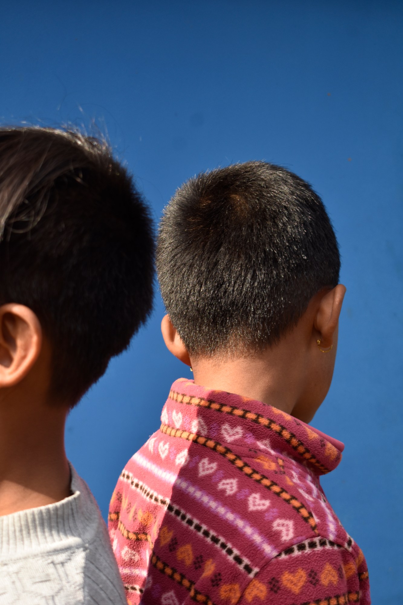 two young boys against a blue sky