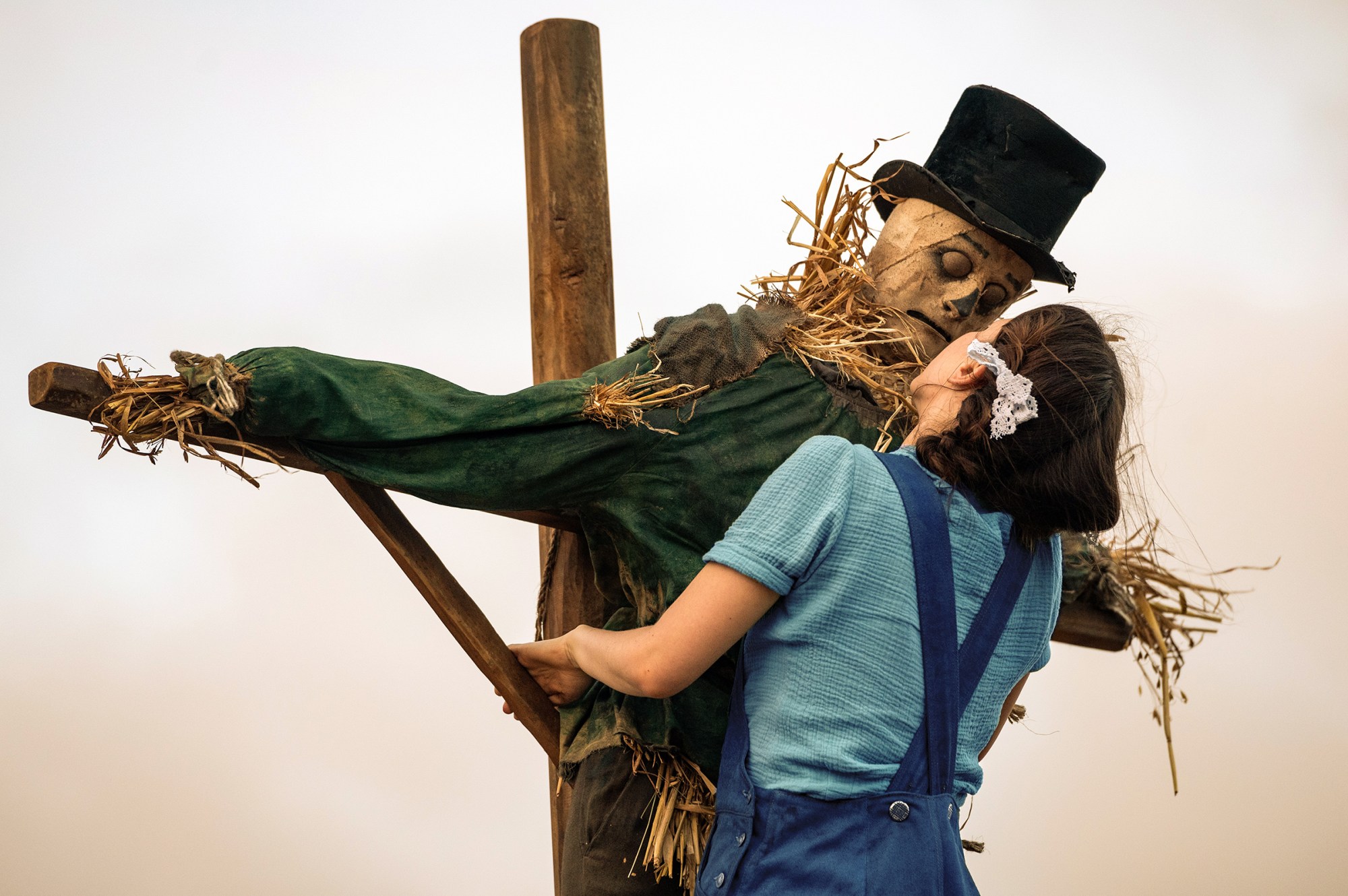 Mia Goth's Pearl hugs a scarecrow