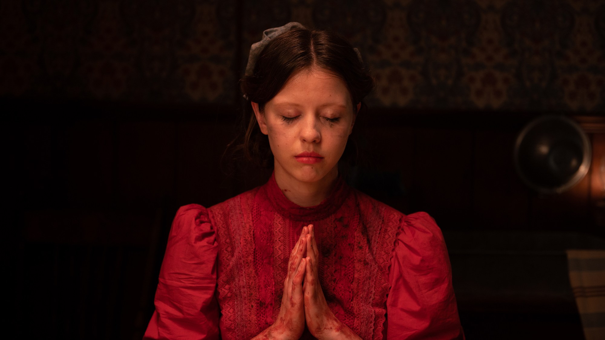 MIA GOTH IN A RED DRESS PRAYING IN PEARL