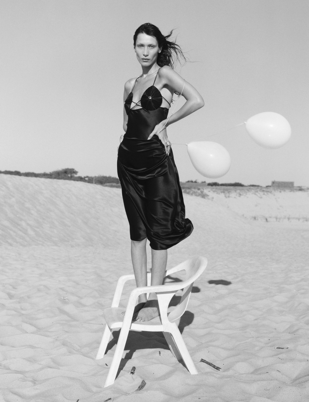 Bella Hadid standing on a chair on the beach photographed by Sam Rock in i-D No. 369 The Ultra! Issue, Fall 2022