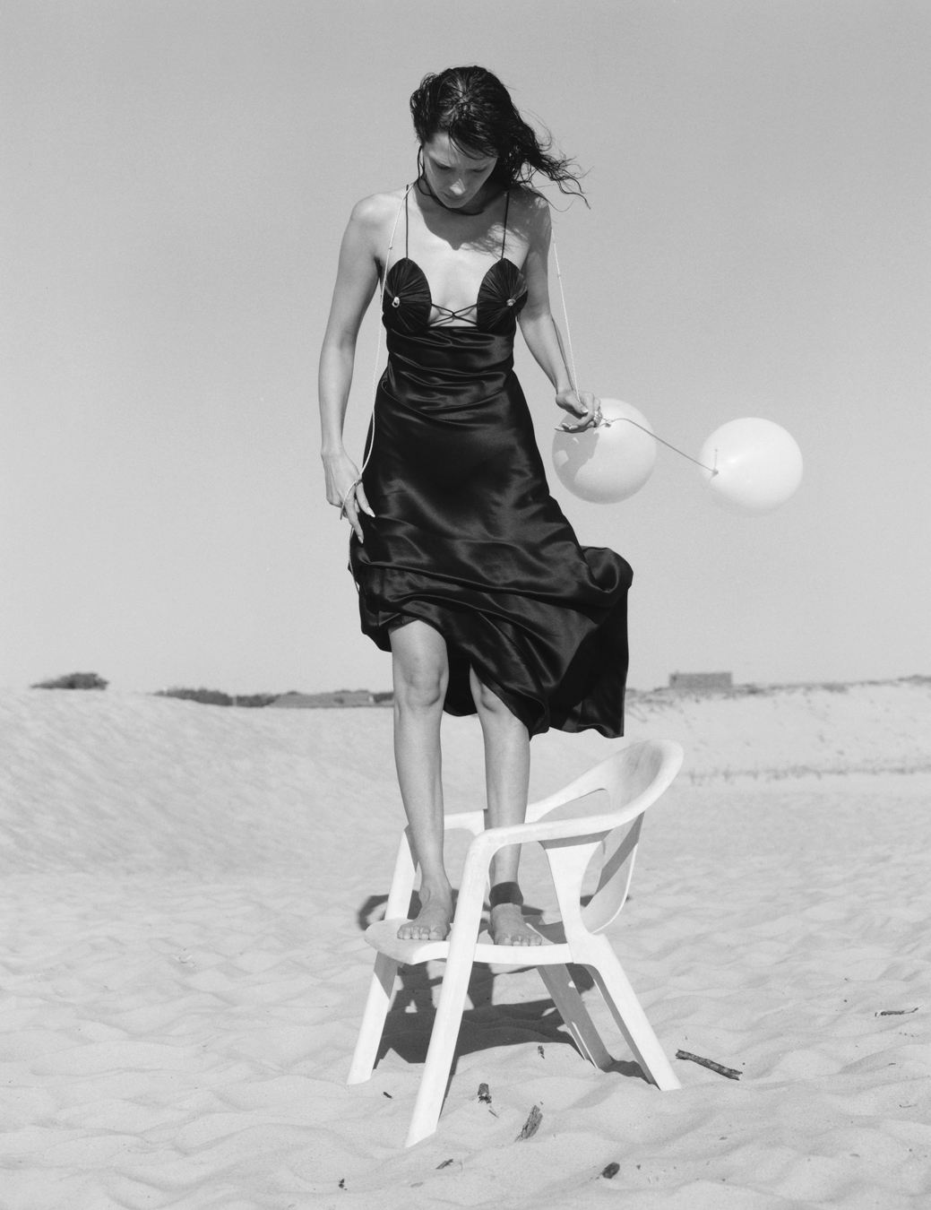 Bella Hadid standing on a chair on the beach photographed by Sam Rock in i-D No. 369 The Ultra! Issue, Fall 2022