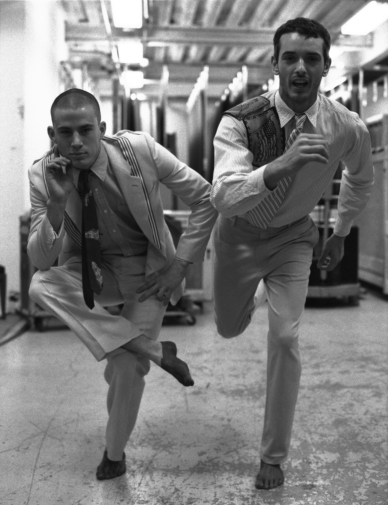 black-and-white image of channing tatum posing with another male model backstage