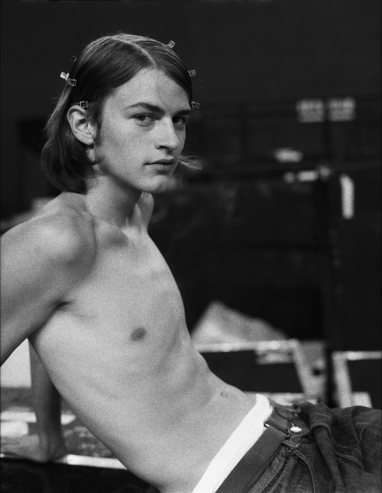 black-and-white image of topless male model backstage at kenzo