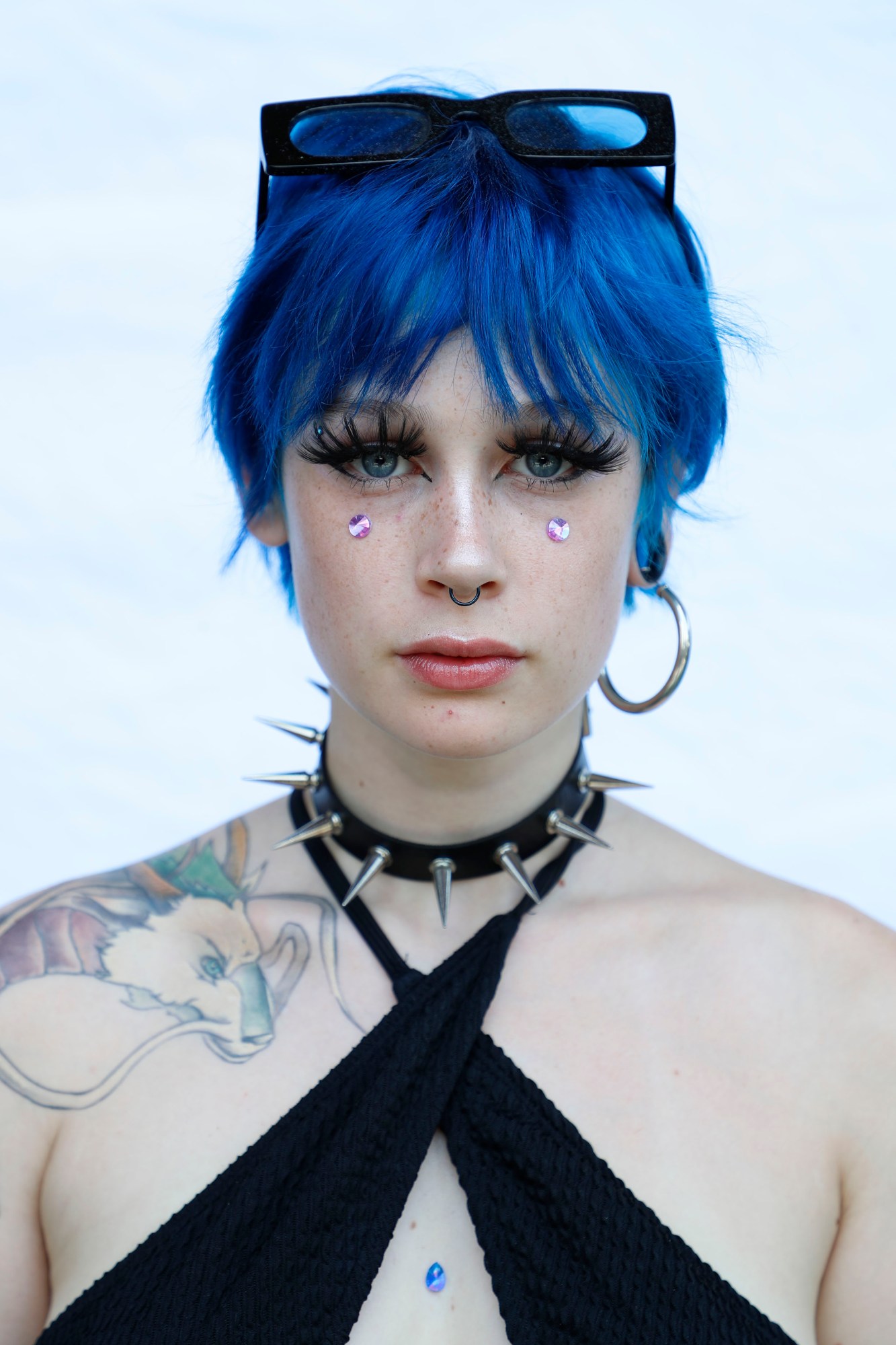 A woman with blue hair and tattoos