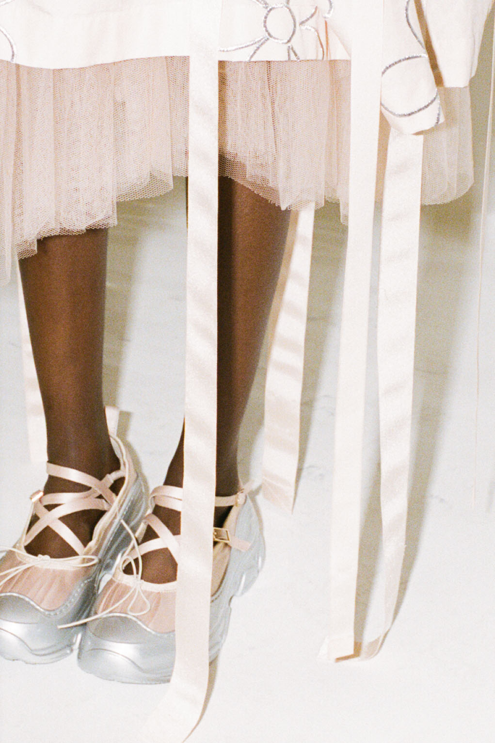 Model behind the scenes at Simone Rocha SS23 in a blush pink dress and shoes