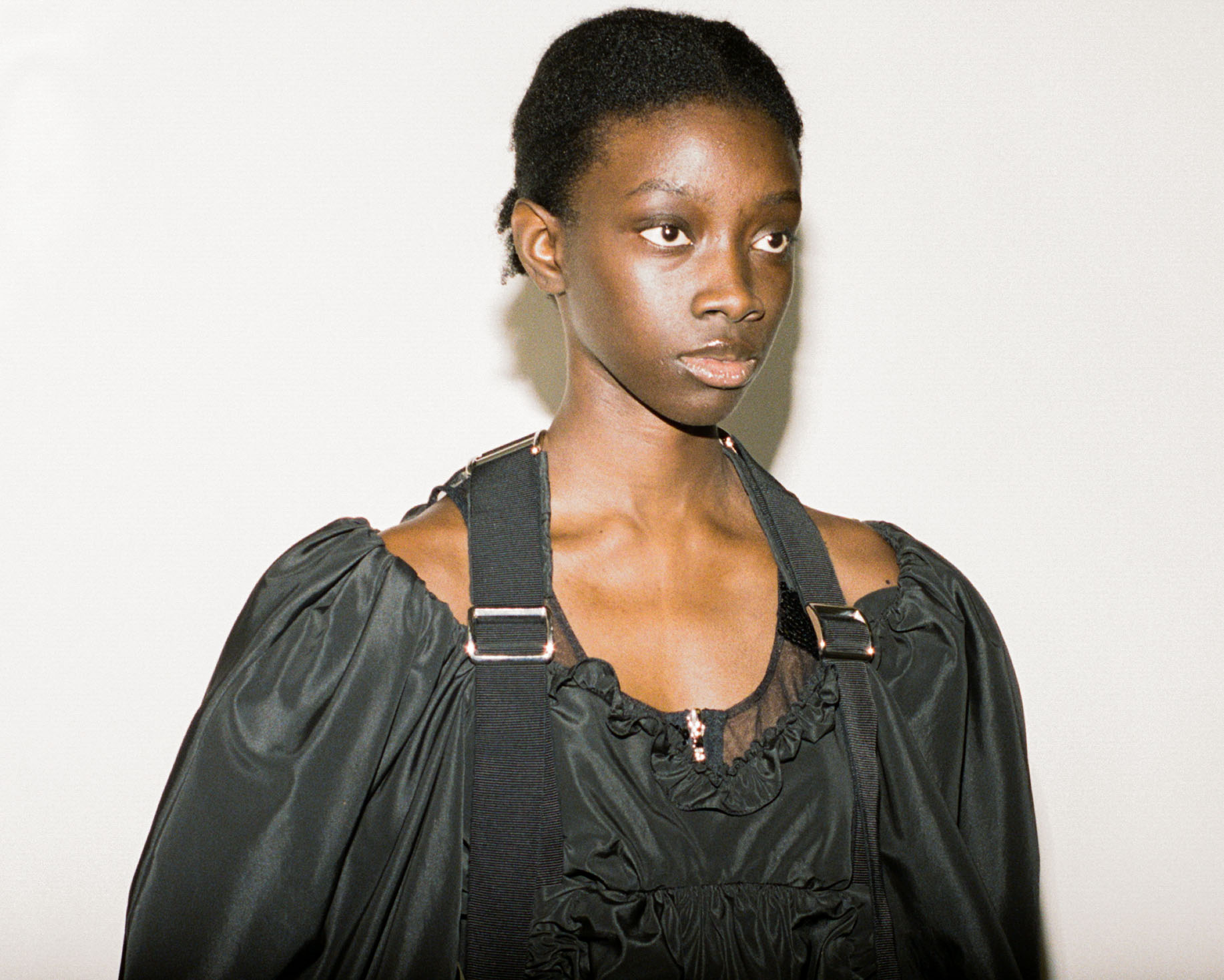 Model behind the scenes at Simone Rocha SS23 in a black dress