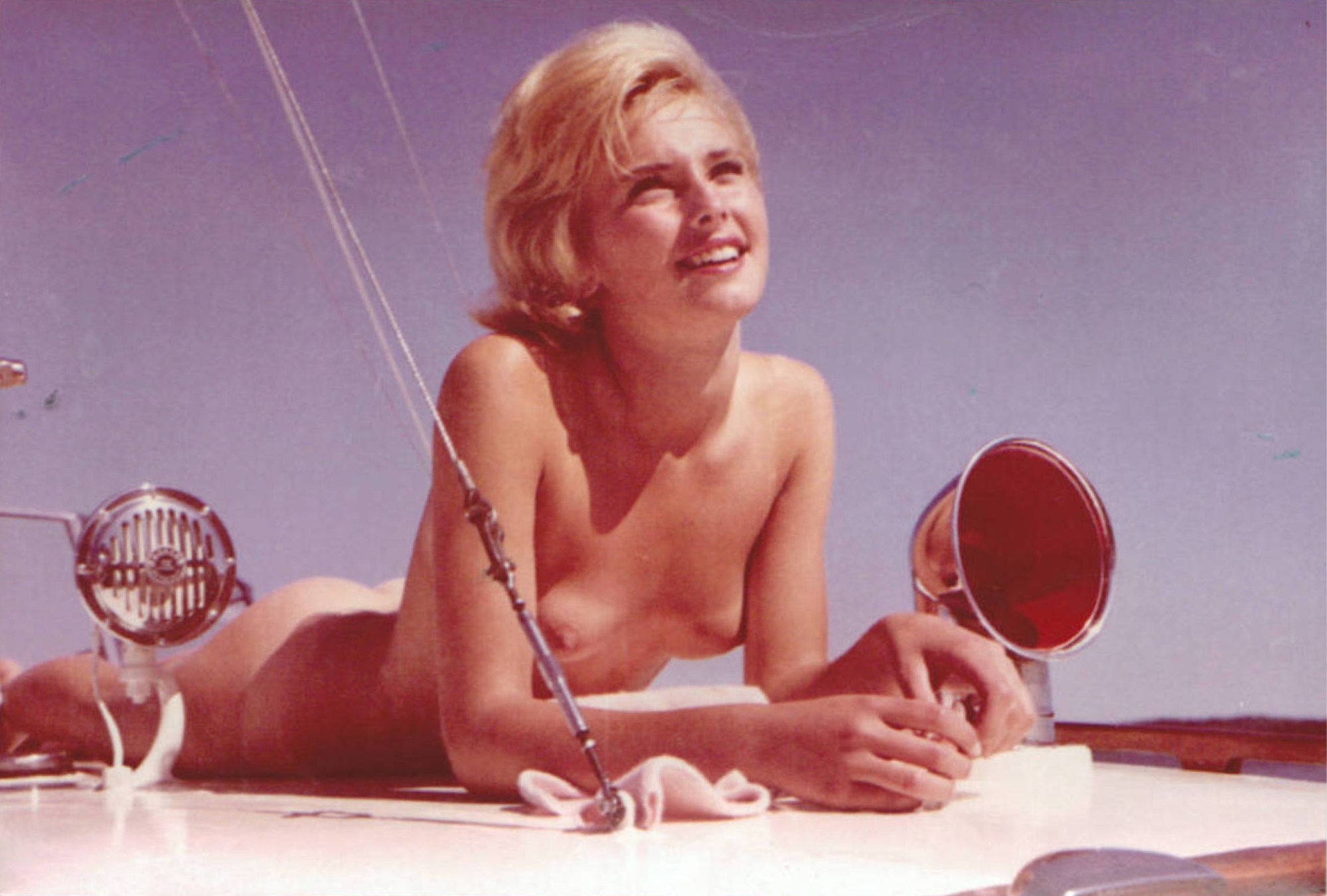 A named woman lying on the deck of a boat in MIDSUMMER NIGHT IN SWEDEN (MITTSOMMERNACHT IN SCHWEDEN), 1964