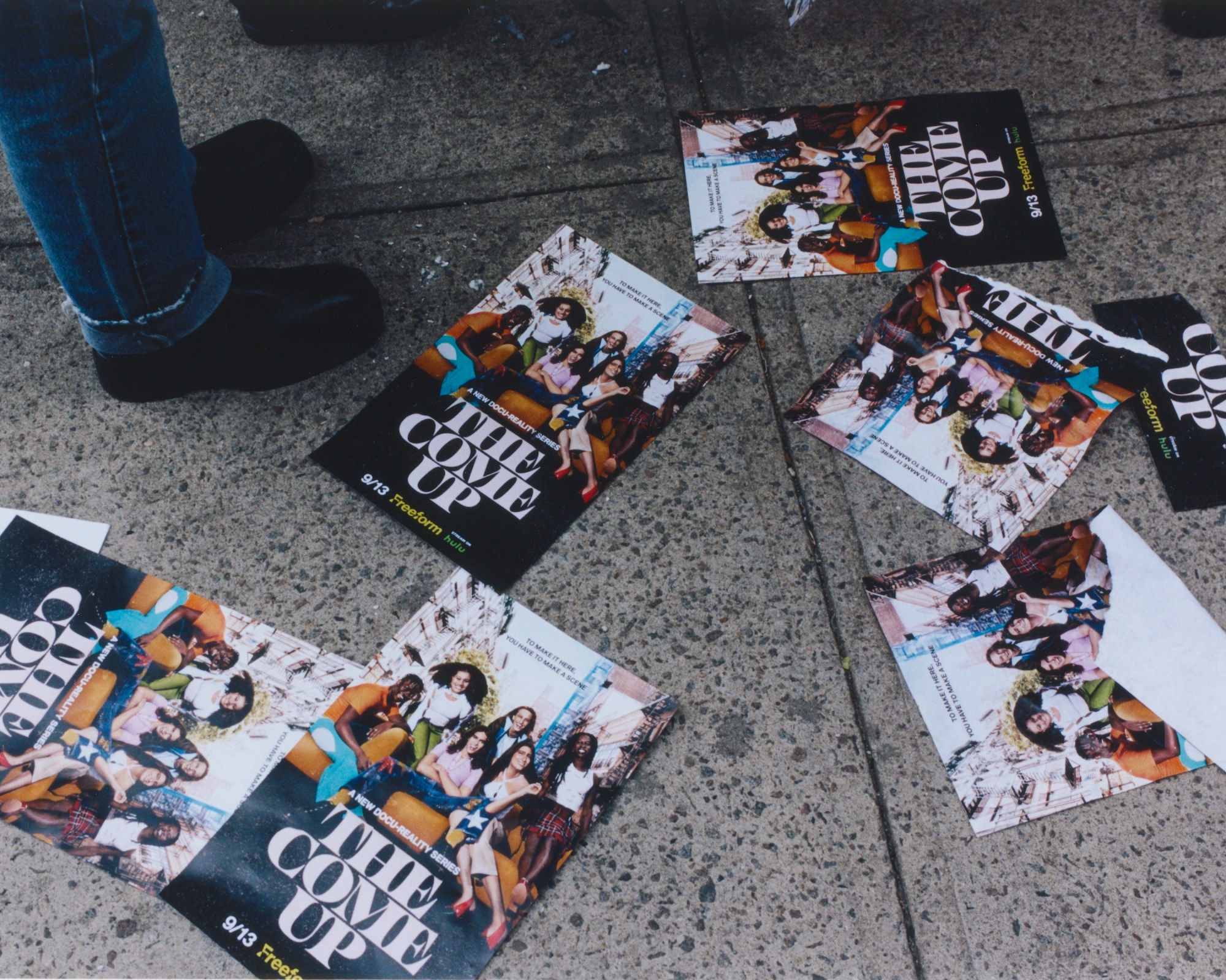 flyers for the come up tv show on a sidewalk