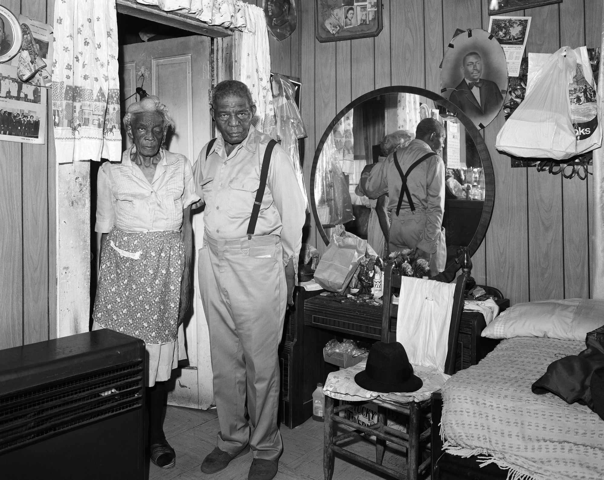 black-and-white photo by Baldwin Lee of an old couple in their bedroom.