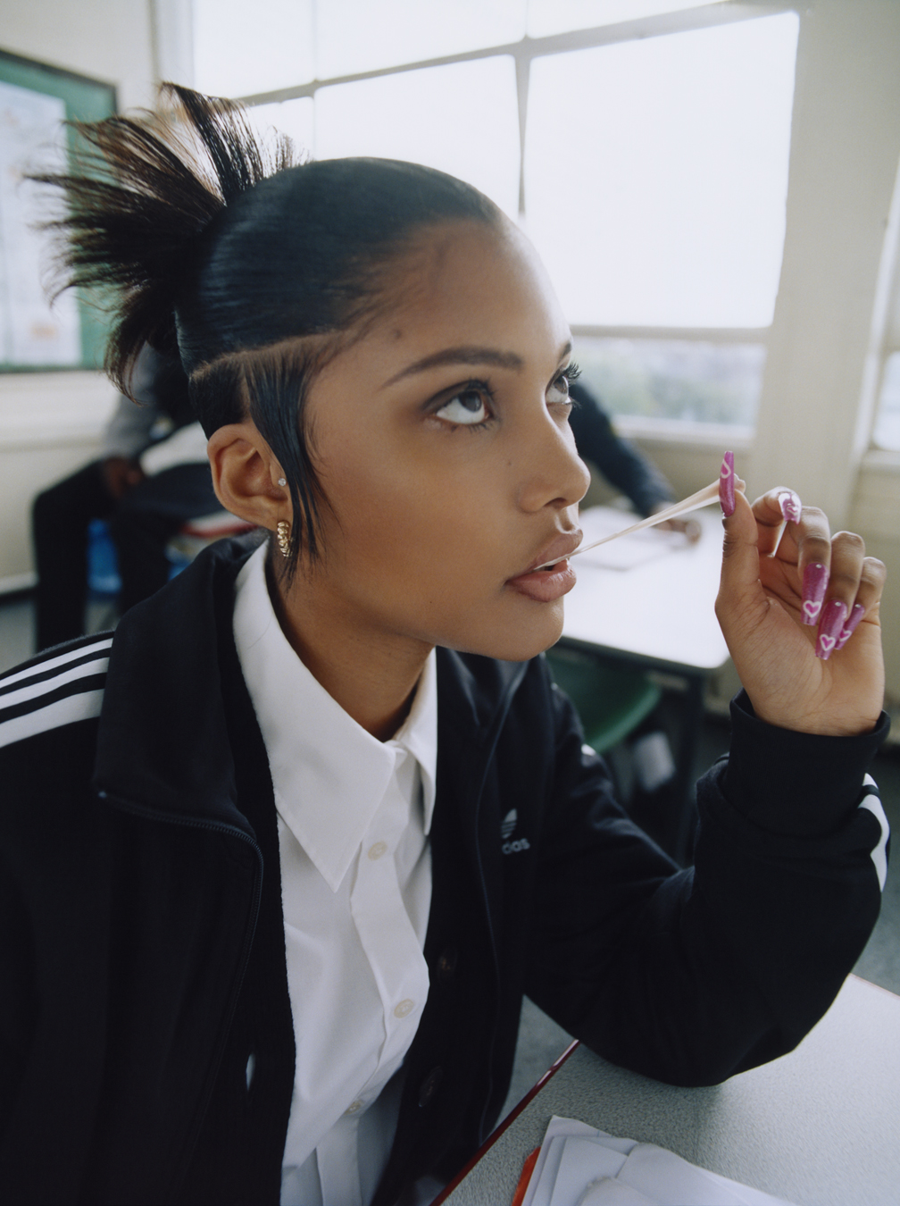 School kid in uniform chewing gum photographed by Bolade Banjo in i-D's The Ultra! Issue, no.369, Fall 2022