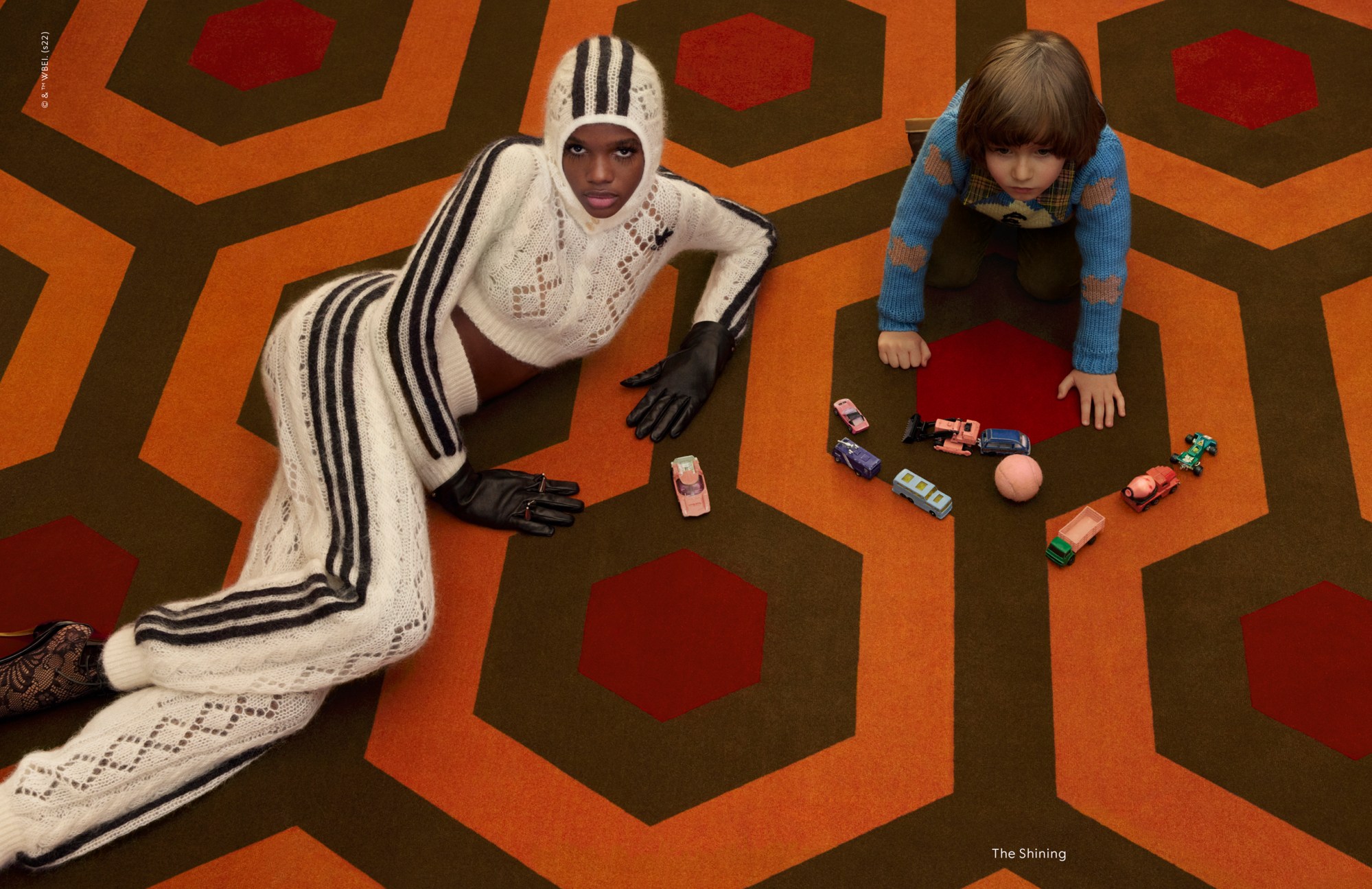 Model in a campaign wearing Gucci AW22 in a scene with Danny Torrance from The Shining