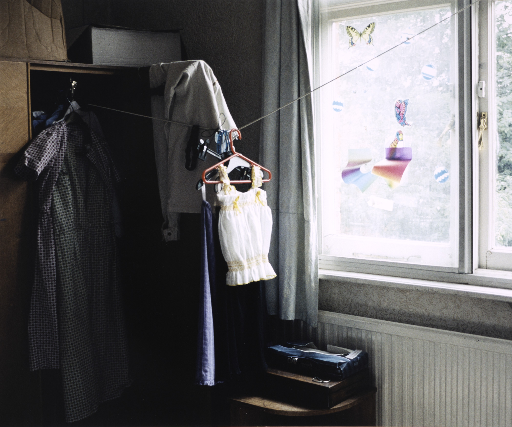 clothes on a washing line hung in a teenager's bedroom