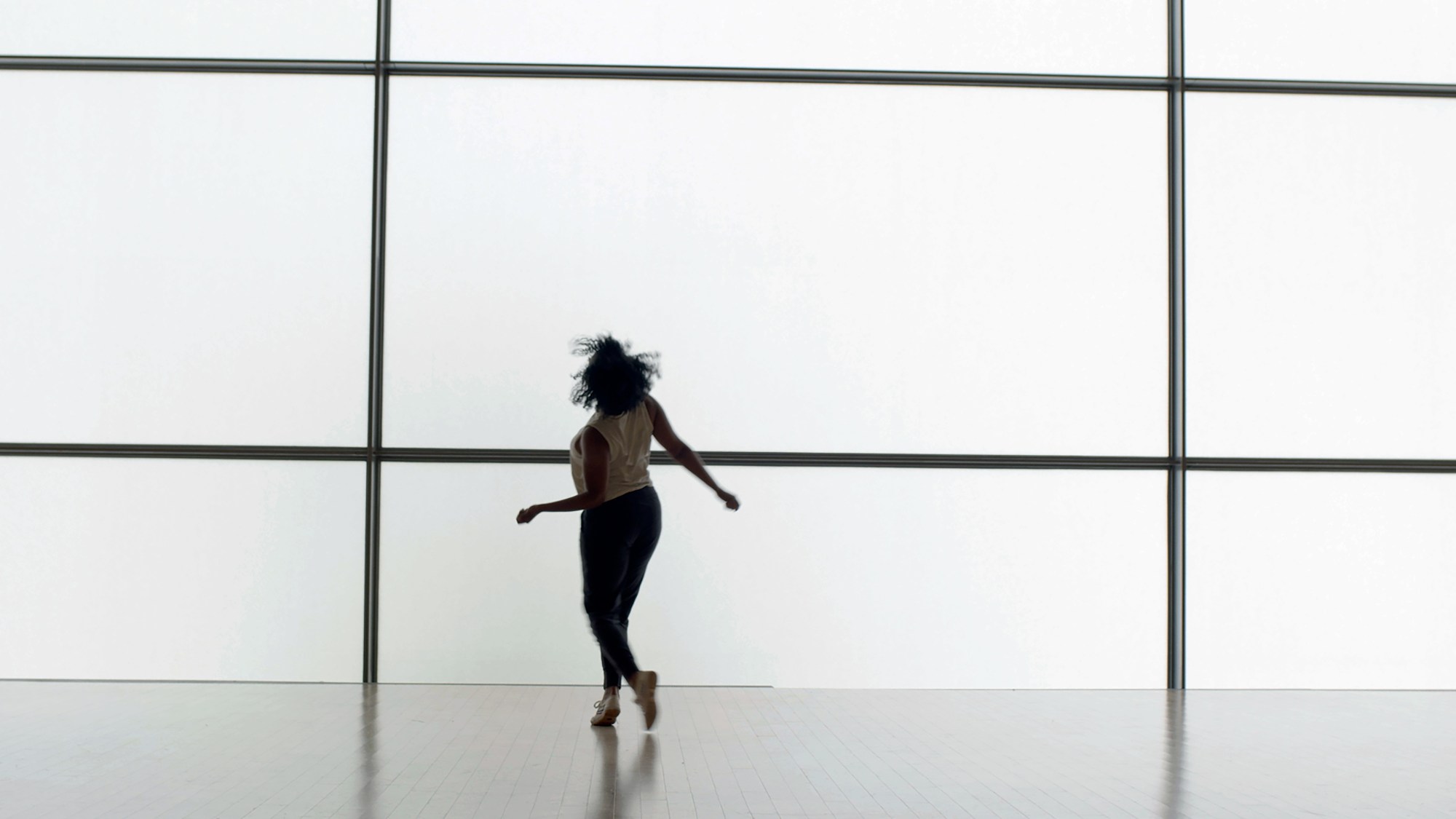 Leslie Cuyjet dancing in a studio.