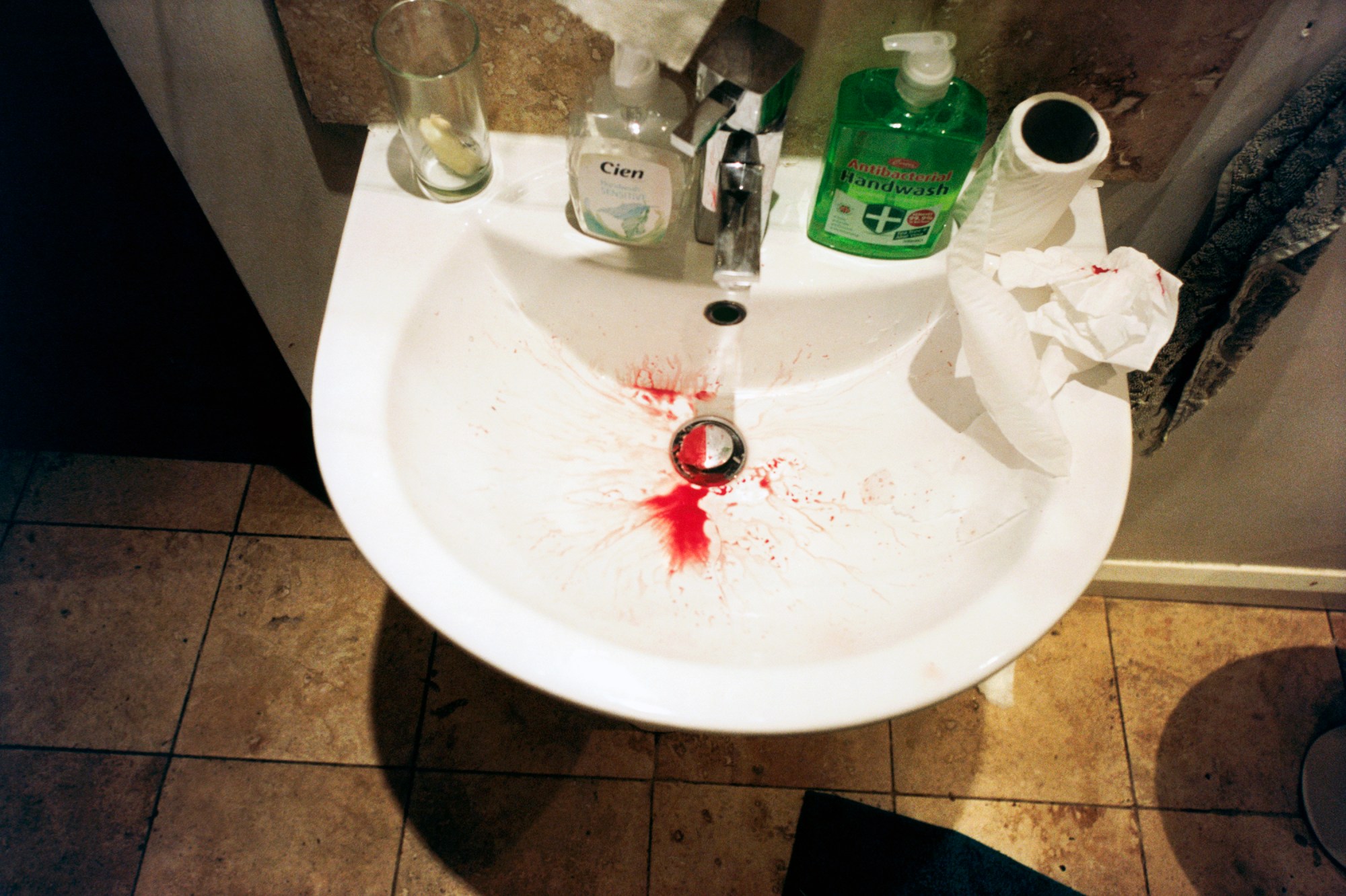 Photo by Evie Shandilya of a sink covered in tissues and blood in the book 'I Just Want to Party'